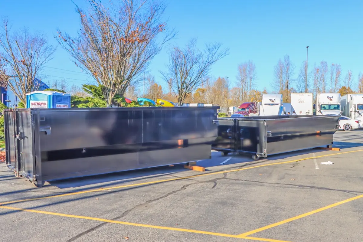 Professional dumpster rental service with roll-off container on residential driveway in Shallotte